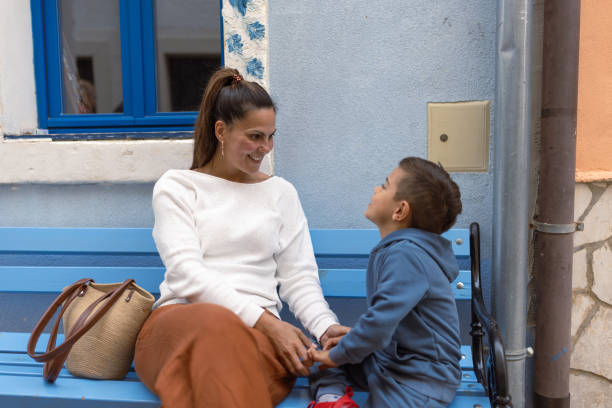 istock Mother and Son Sharing a Moment on Blue Bench Outdoors 2194244840