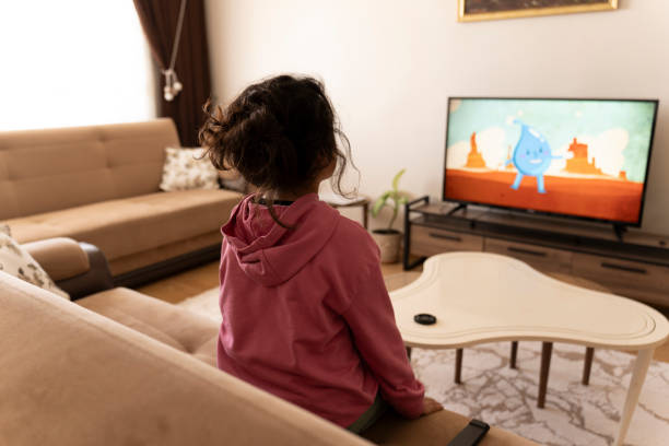 istock Girl watching TV. 2194246297