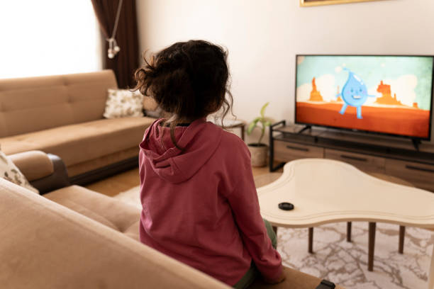 istock Girl watching TV. 2194246299