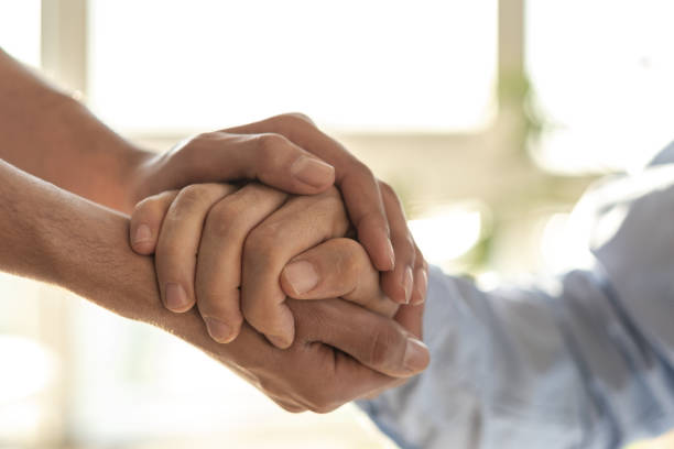 istock Doctor comforting patient by holding hands, showing empathy and support 2194247213
