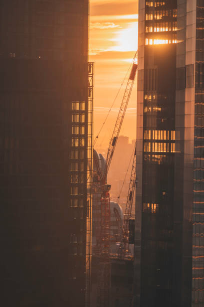 istock Cranes Framed by Skyscrapers at Sunset in London, UK 2194248599