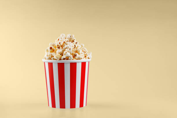 istock Classic red striped popcorn cardboard cup on Yellow background 2194249410