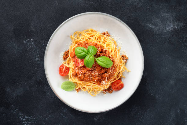 istock spaghetti bolognese with fresh basil leaves 2194250218