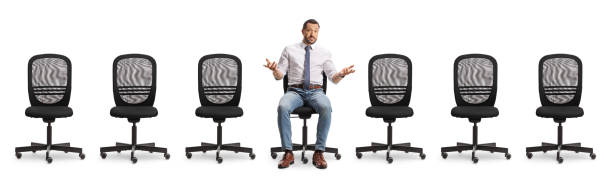 istock Worried man sitting alone between office chairs 2194250246