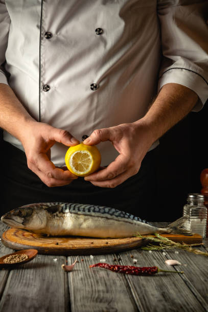 istock A skilled chef prepares a fresh fish with a zesty lemon in a cozy kitchen, surrounded by spices and ingredients, showcasing the artistry of culinary creation 2194250524