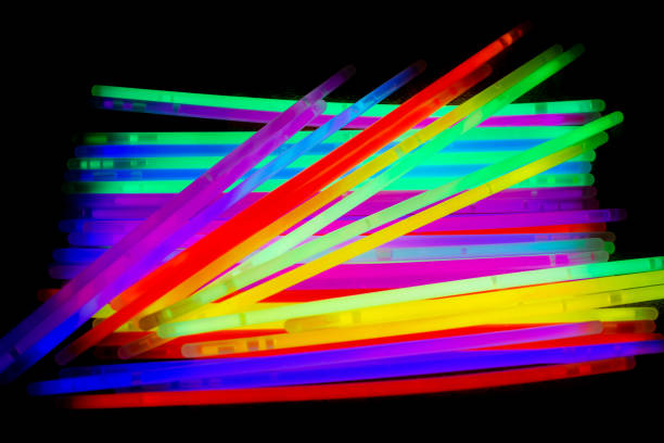istock Colorful party glow sticks on black background 2194250838