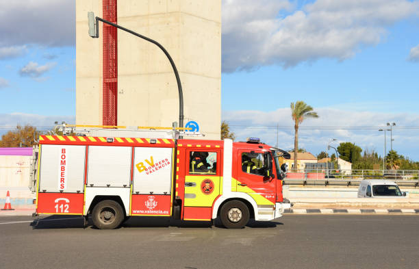 Fire truck drives down the street for emergency response. 112 Fire truck vith firefighters. December 09, 2021, Spain, Valencia.