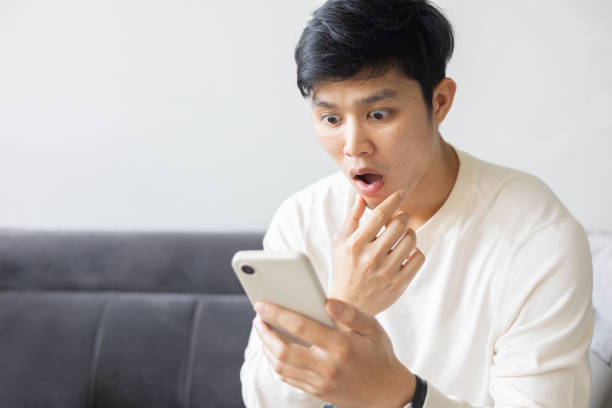 istock close up young asian man using smartphone with emotional surprise and excited feeling after become a winner on online lottery game monthly from website for lifestyle people concept 2194251408