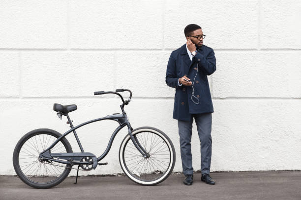 istock Young Man Stands by Bicycle While Listening to Music in Urban Setting 2194252692