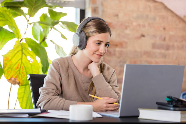 istock Young Woman Using Laptop, Headphones, Casual, Studying 2194256318