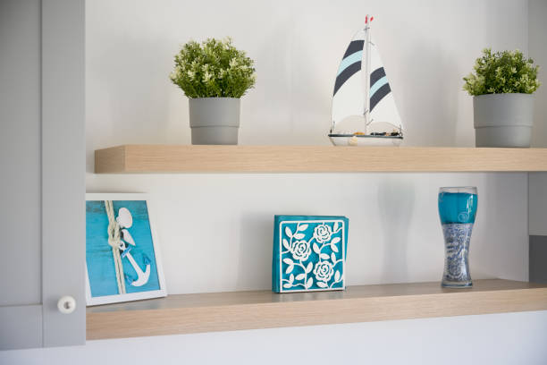 Nautical Themed Shelf Display with Sailboat and Plants