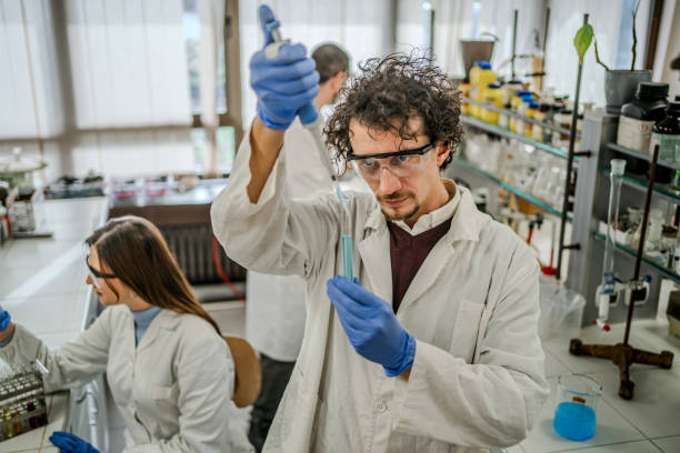 istock Scientist pipetting samples into in a test tube 2194258073