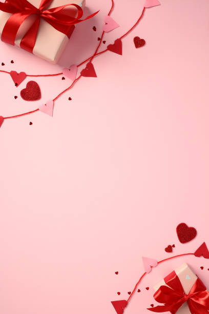 istock Valentine's Day gift box with red ribbon, surrounded by red and pink heart decorations on a pink background. Perfect for romantic, love concepts 2194264507