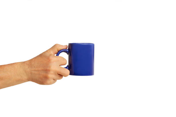istock Man hand holding a blue mug on a white background with copy space 2194264748