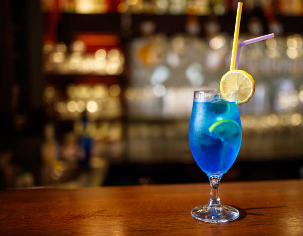 istock Refreshing Blue Cocktail with Lemon Garnish on Wooden Bar Counter 2194265116