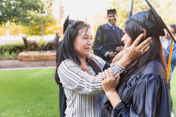 istock Proud Mom Embraces Daughter at Graduation 2194268881