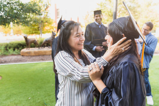 istock Proud Mom Embraces Daughter at Graduation Ceremony 2194268886