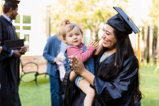 istock Happy Graduate Holding Child, Graduation Celebration 2194268901