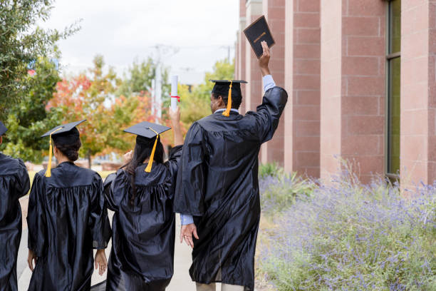 istock Happy Graduates Walking Away from University Campus 2194268936