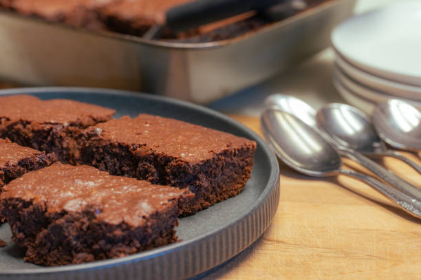istock Plates, spoons, and brownies on the kitchen counter. 2194269079