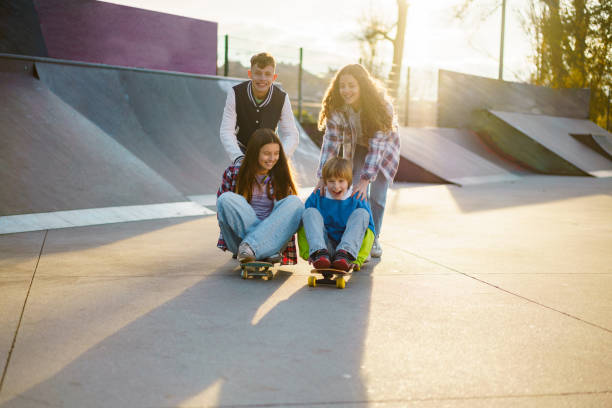 istock Children have fun skateboarding in the park 2194269957