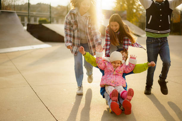 istock Group of joyful children having fun in skateboard park 2194271088