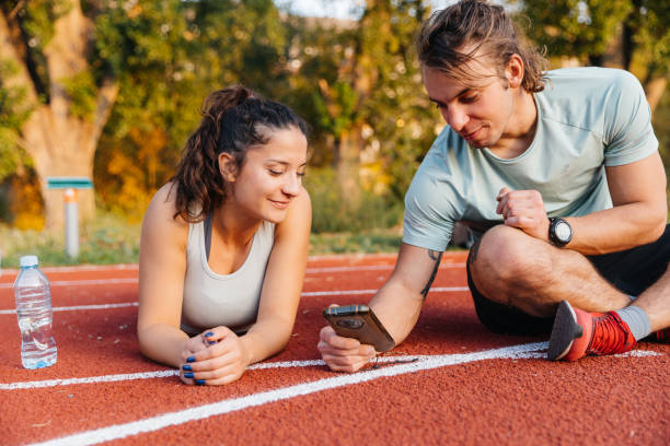 istock Young couple resting after running on a track 2194274305