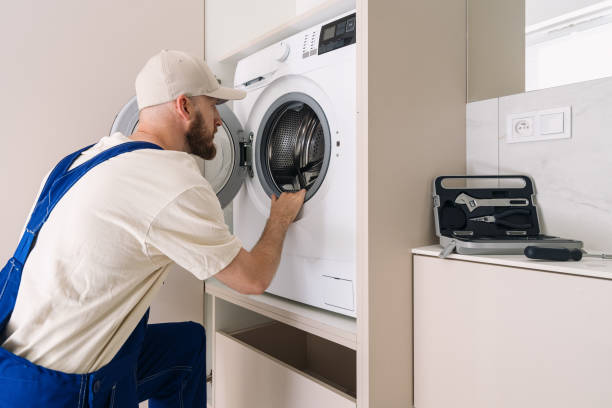 istock Laundry technician servicing modern washing machine in a stylish apartment 2194274659