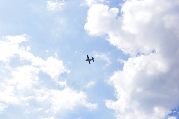 istock Small airplane in a blue sky with clouds 2194279240