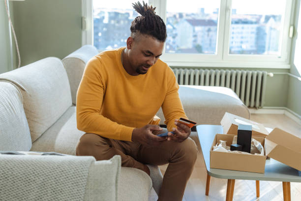 istock Man shopping online at home using mobile phone and credit card 2194279763