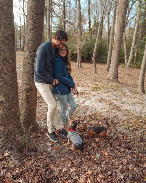 istock Fall Winter Couples Portrait with Puppies - Forest - Leaning on Tree - Candid 2194280033