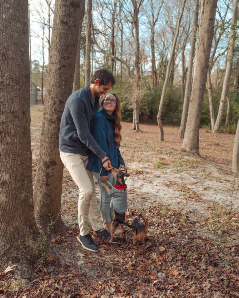 istock Fall Winter Couples Portrait with Puppies - Forest - Leaning on Tree 2194280553