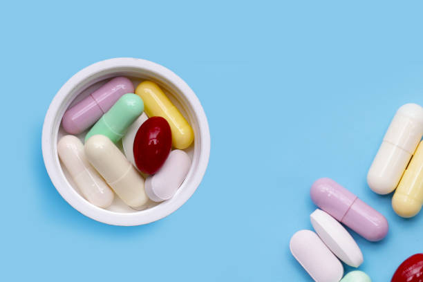 istock Colorful capsules and pills on blue background. 2194280579