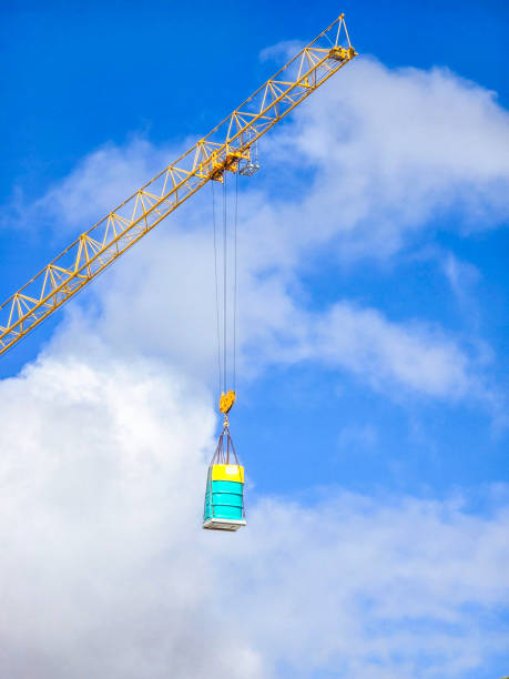 A close-up shot of a crane hook lifting heavy chains, showcasing industrial strength and precision. Perfect for construction, engineering, and heavy machinery themes.