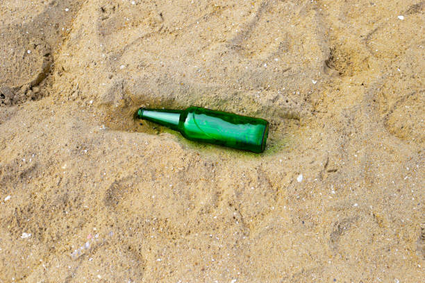 Green glass bottle on the beach