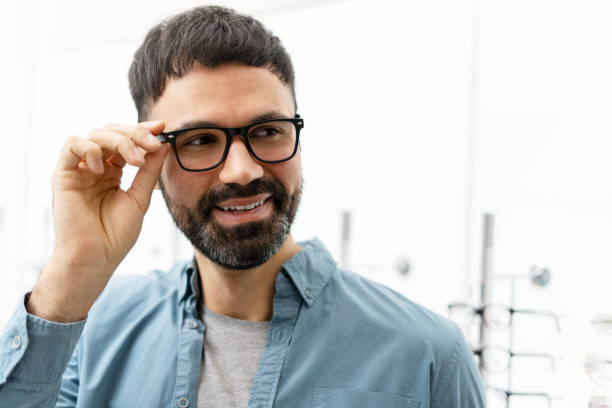 istock Handsome bearded man trying eyeglasses in optical store 2194288146