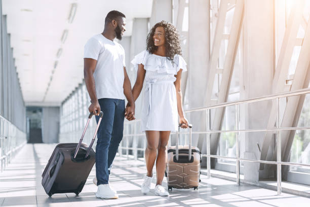 istock Affectionate Black Couple Enjoying Honeymoon Trip, Walking With Suitcases In Aiport 2194290915