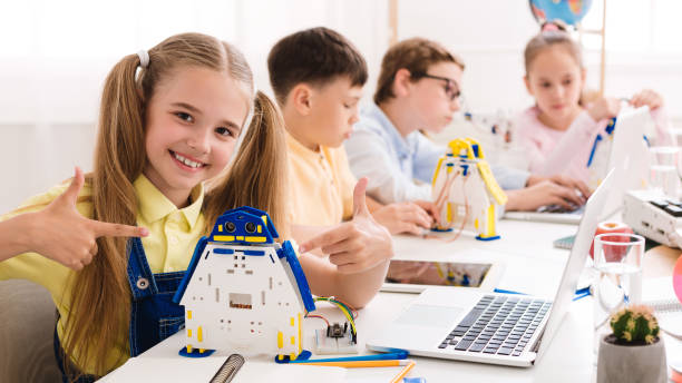 istock Young Students Engage in a Robotics Workshop While Showcasing Their Creations at a Bright Classroom 2194291340