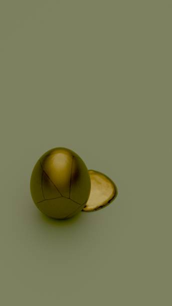 istock Big golden egg cracked and spilling its yolk into a puddle 2194291660