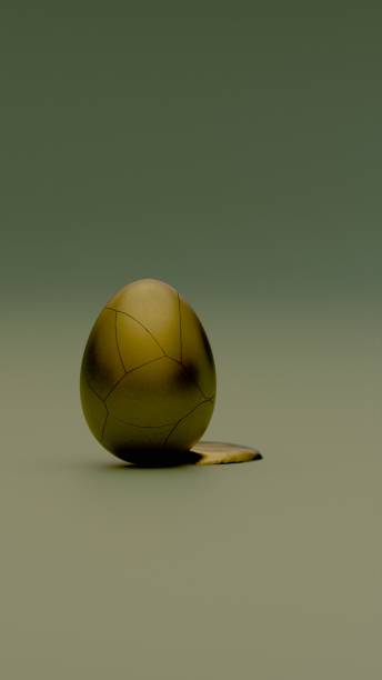 istock A cracked golden egg spilling yolk and positioned on a smooth surface 2194291665