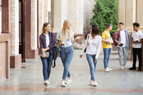 istock Happy students walking in university hall during break 2194291739