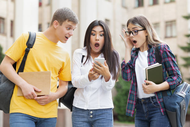 istock Shocked students checking exams results online on smartphone 2194291742