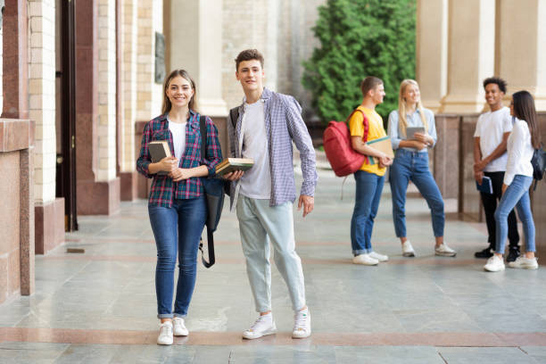 istock Happy students in university campus smiling to camera 2194291747