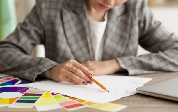 istock Creative Process of a Designer Sketching Ideas Using Color Swatches in a Studio 2194292539