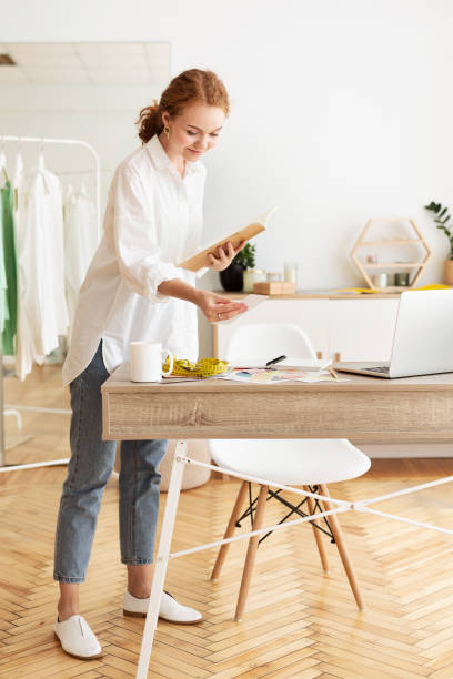 istock Tailor girl checking customer order list, working in atelier 2194292585