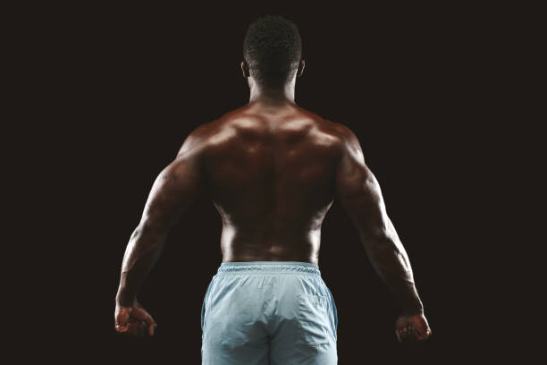 istock Bodybuilder Showcasing Strong Back Muscles and Physique Under Studio Lighting 2194292646