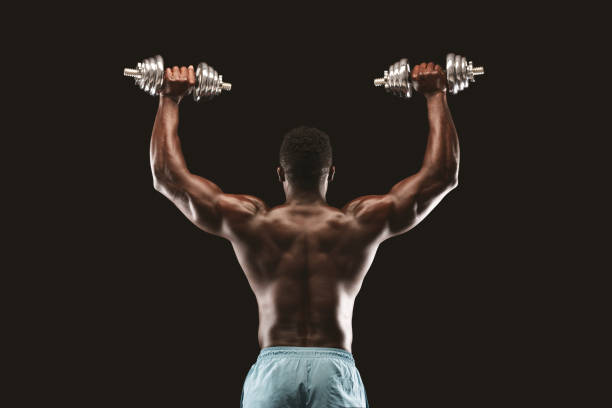istock Strong Individual Performing Weightlifting Exercise in Gym Setting With Focus on Strength Training 2194292673