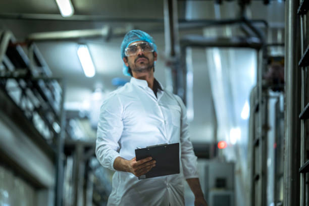 istock Professional worker analyzing operational data on production equipment in a state-of-the-art food factory Prioritizing efficiency and safety compliance. 2194295744