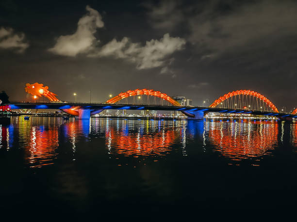 istock Dragon Bridge Illuminated at Night with Reflections in Water 2194296824