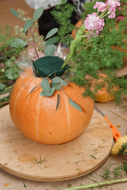 istock Creating a floral composition in a pumpkin. Making decor with your own hands. 2194297639